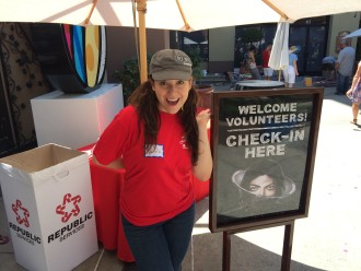 Aurora with the volunteer check-in sign at the Pasadena Chalk Festival