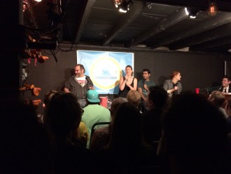 People laughing onstage at Harmontown