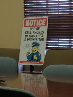 Cell phones prohibited sign at The Simpsons table read