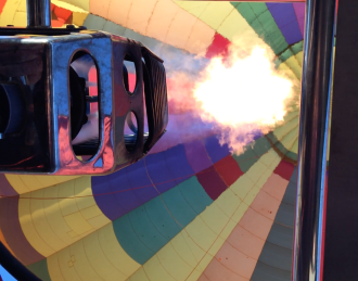 fire going up into a hot air ballon
