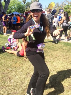 Aurora excited in the grass happily with her medal after the Sunset Strip Half Marathon 2015