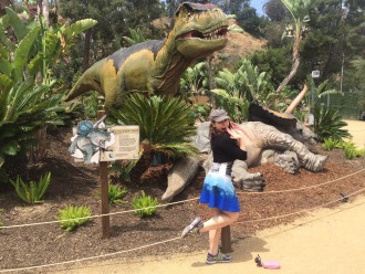 Aurora with her leg up at the dinosaur exhibit at the LA zoo
