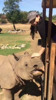 Aurora smiling petting the rhinos horn