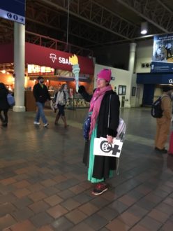 woman at Union Station in DC fressed like the statue of liberty in a pink pussy hat before the women's march