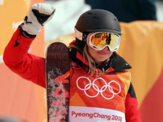 Elizabeth Swaney holding her board at the Olympics