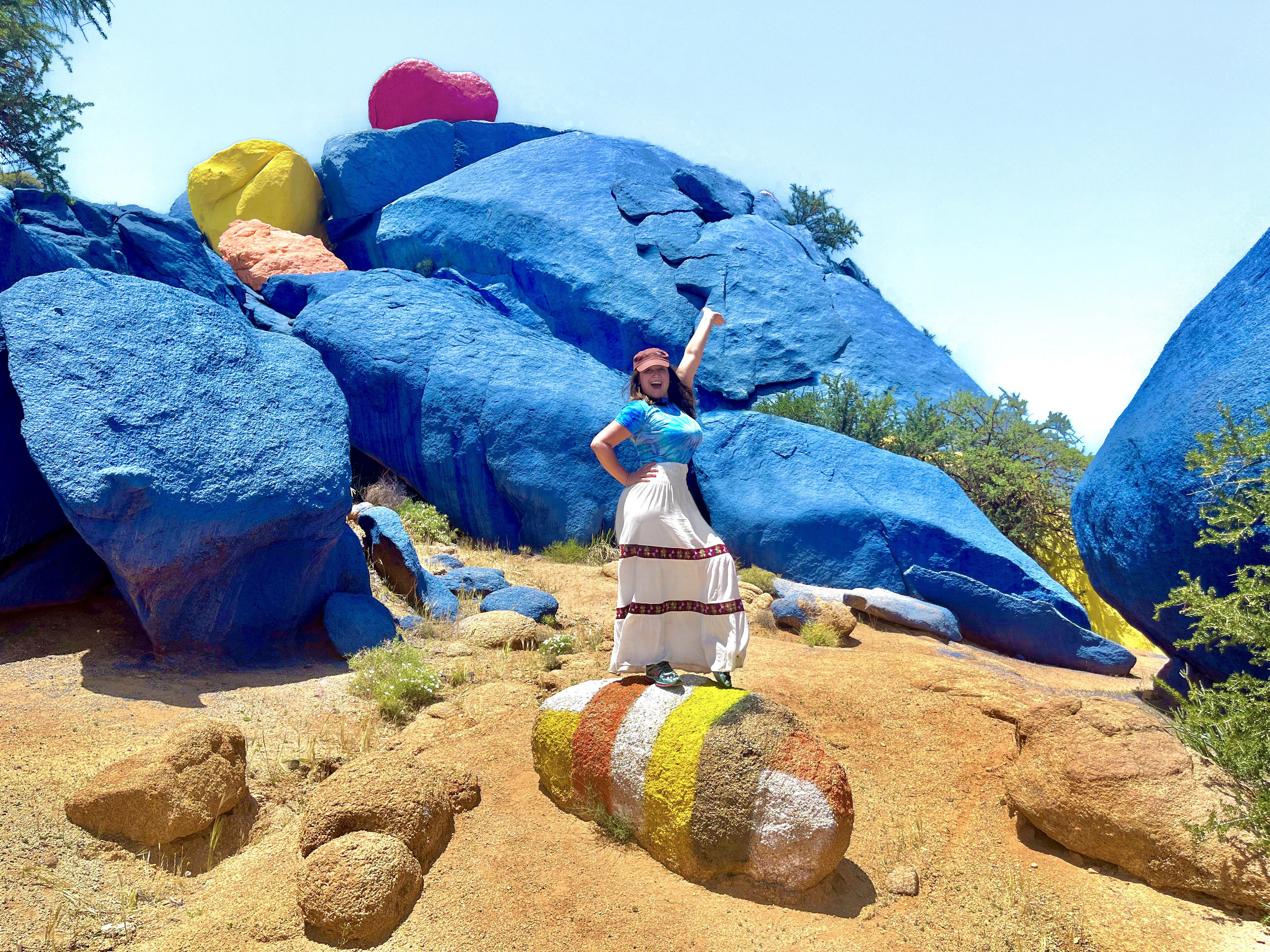 Aurora De Lucia, standing on colorful rocks in Tafroute Morocco